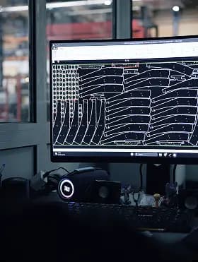 A computer screen showing a complex nested laser cutting layout pattern for manufacturing sheet metal parts